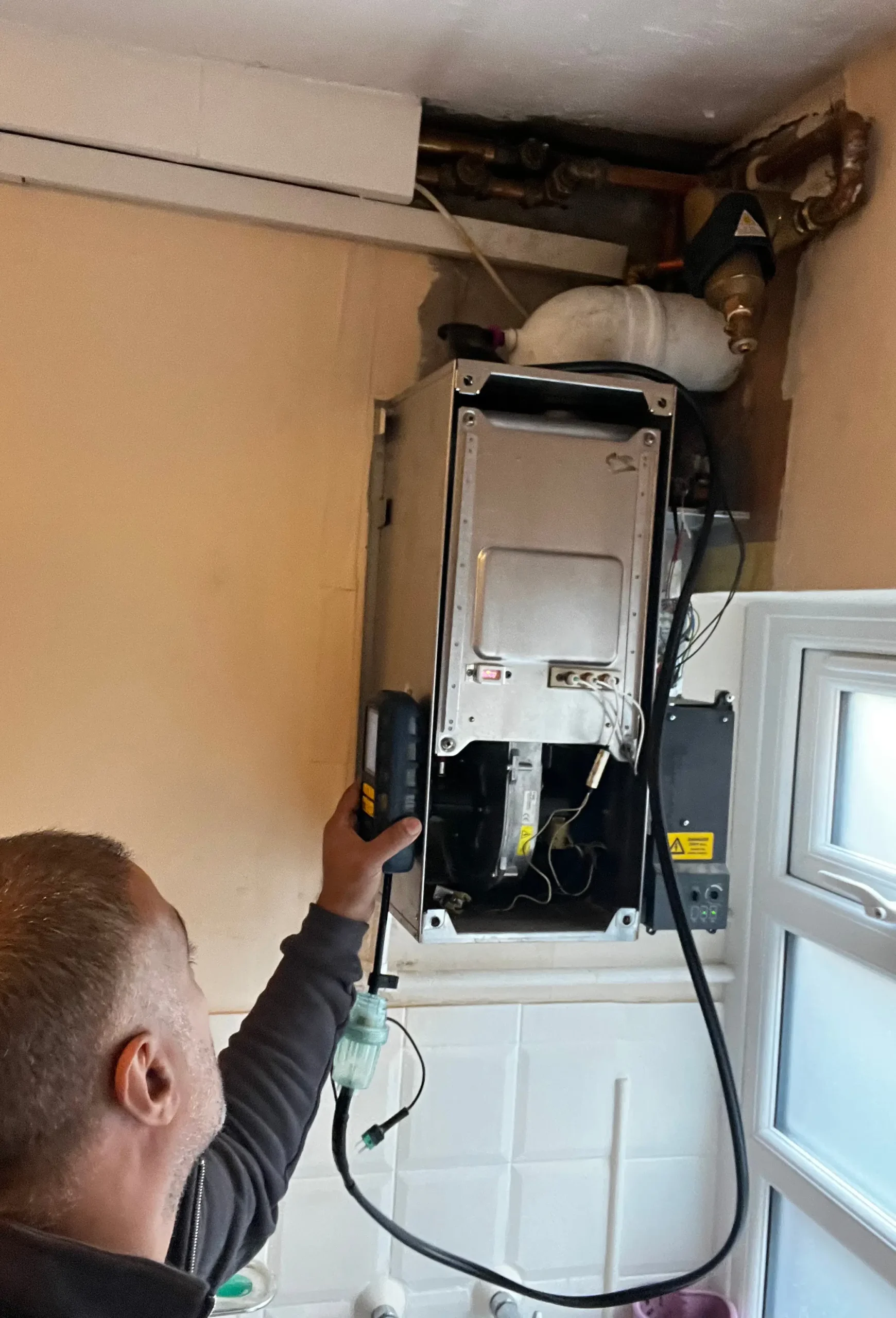 Gas Safe engineer repairing a boiler in Harrow